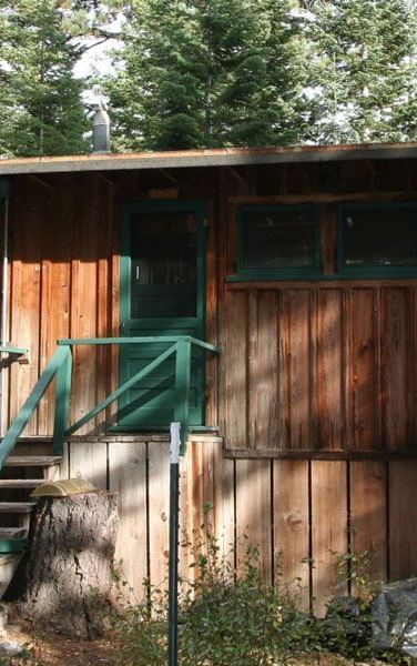 A rustic wooden cabin exterior at Kit Carson Lodge.