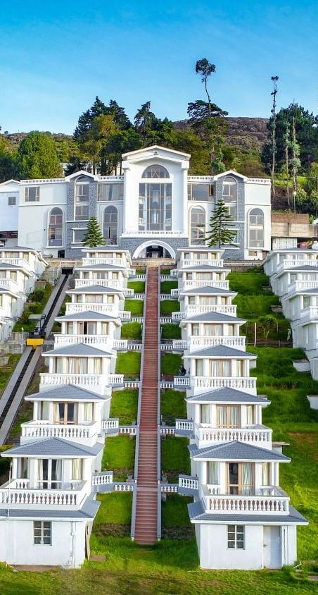 La Montana By TGI, Ooty with white buildings surrounded by trees
