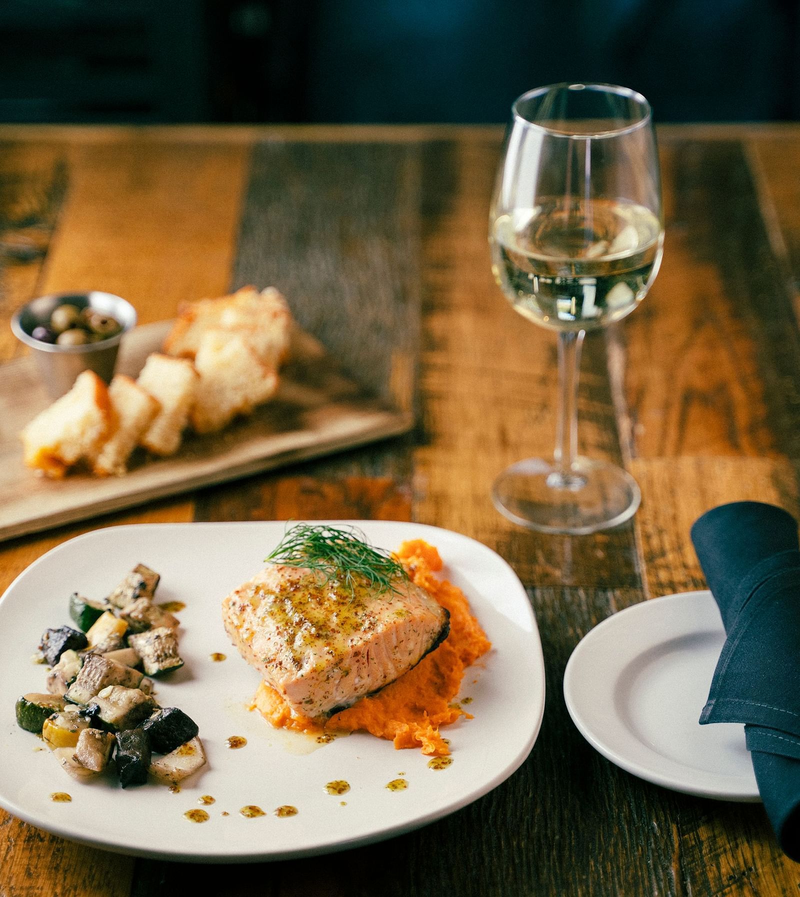 A view of a dish served alongside a glass of champagne