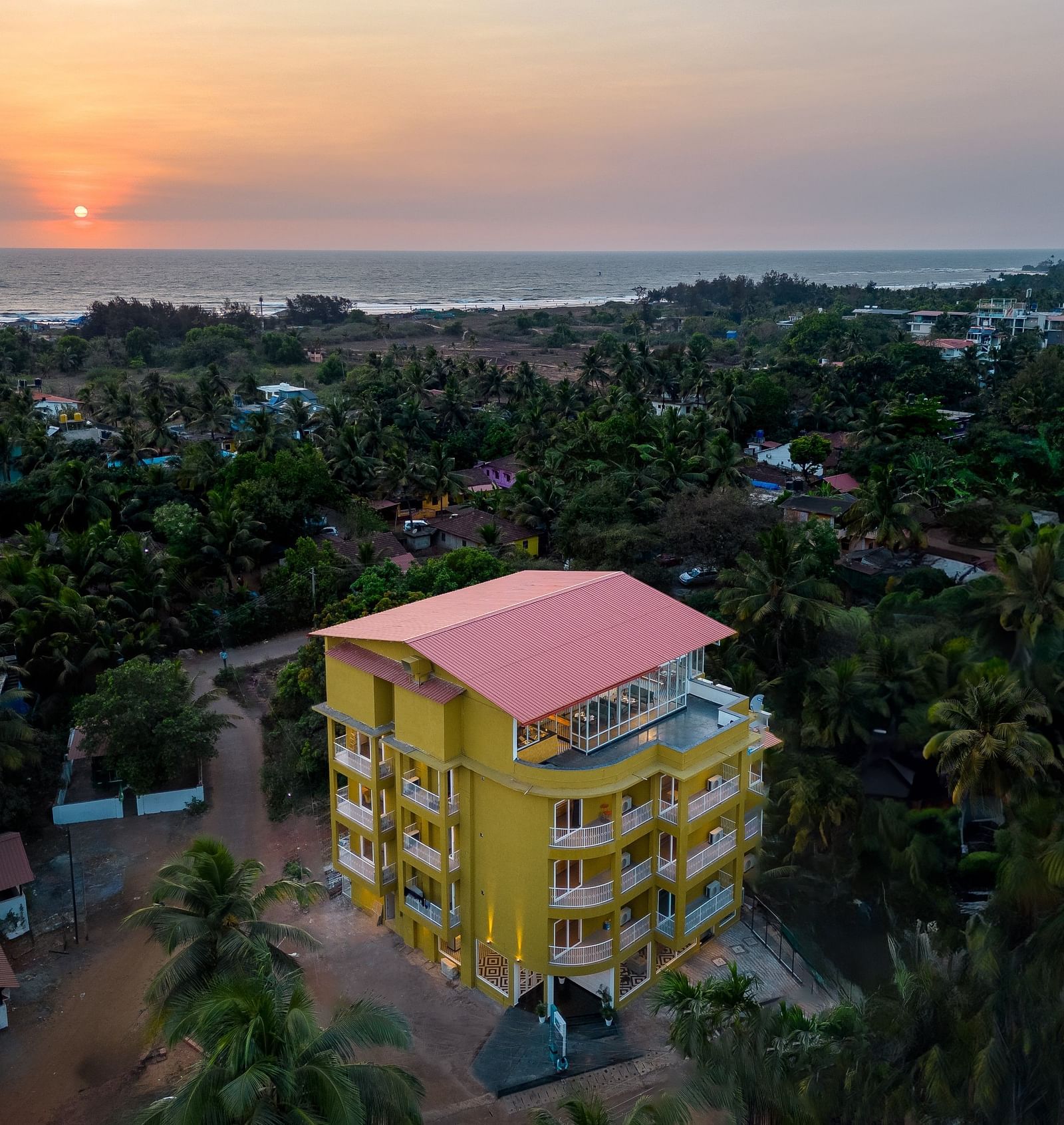 An aerial view image of a facade surrounded by trees - Bedzzz Xclusiv Morjim, Goa