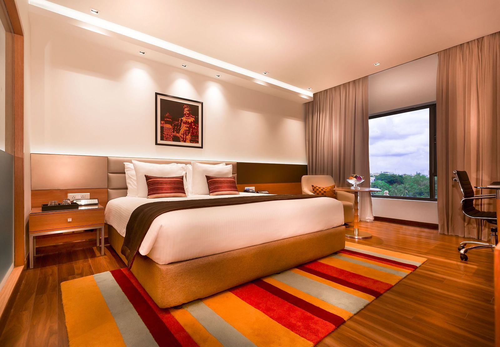 Business Class Room with a king size bed and a TV at Grand Chennai By GRT Hotels.