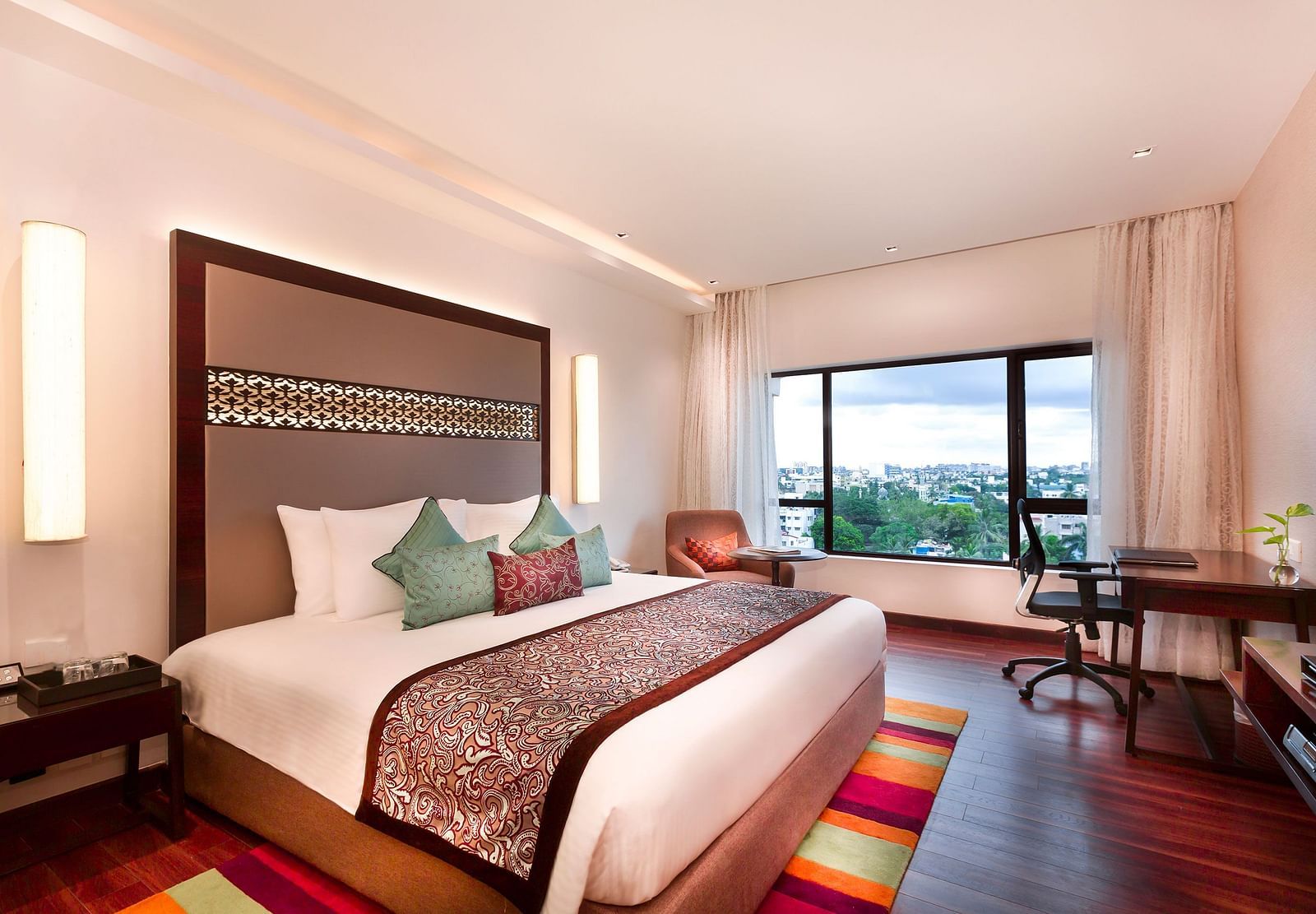 Serene Room with a king size bed and a work desk with a chair at Grand Chennai By GRT Hotels.