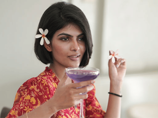 a girl holding a cocktail glass at The Residency Towers Rameswaram