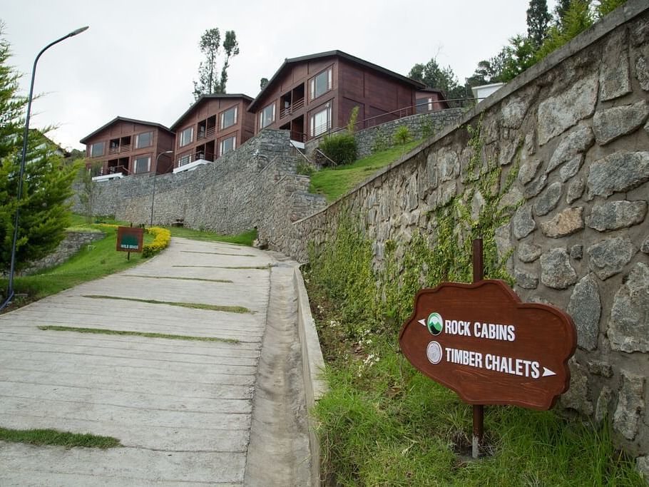 A facade image of the trail leading to the Rock Cabins surrounded by lush greenery - GReaT Trails Kodaikanal By GRT Hotels
