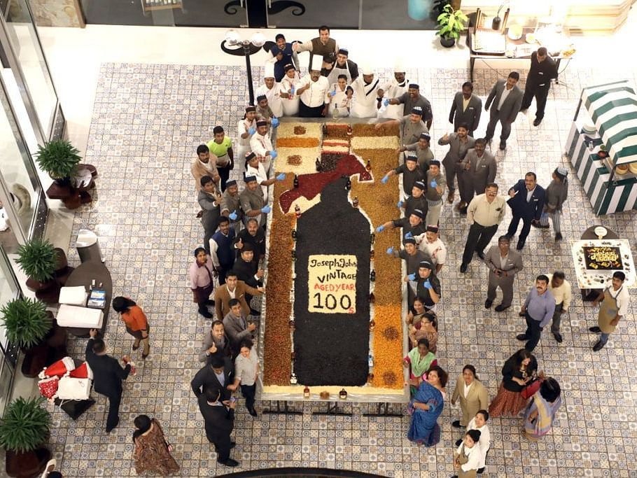 Overhead shot of staff mixing ingredients for a cake.