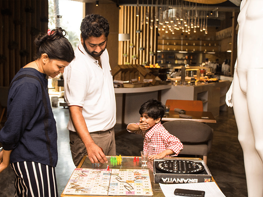 Family enjoying a board game together at a recreation area.