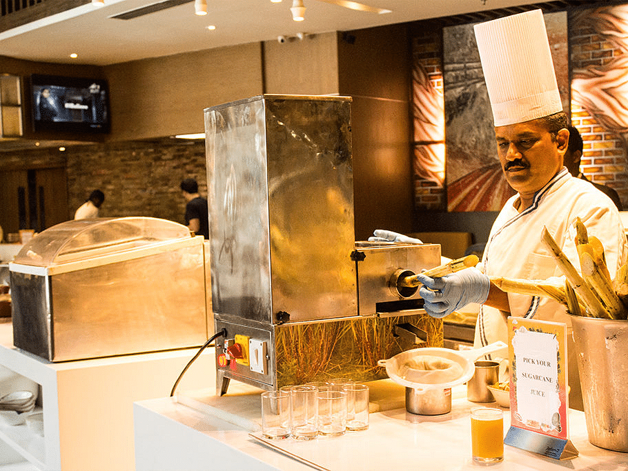 Chef preparing dishes in a modern kitchen with a tandoor oven