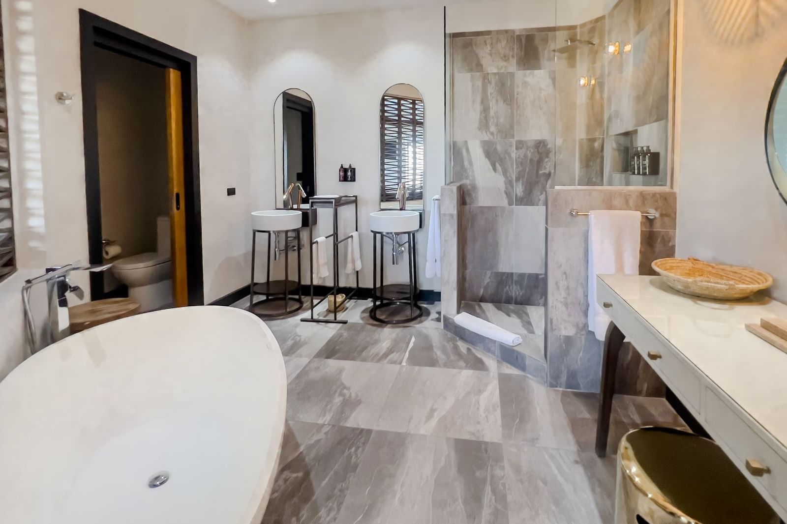 A bathroom with a tub, two sinks and a vanity and a shower area at Tamarind Hills Resort and Villas, Antigua. 