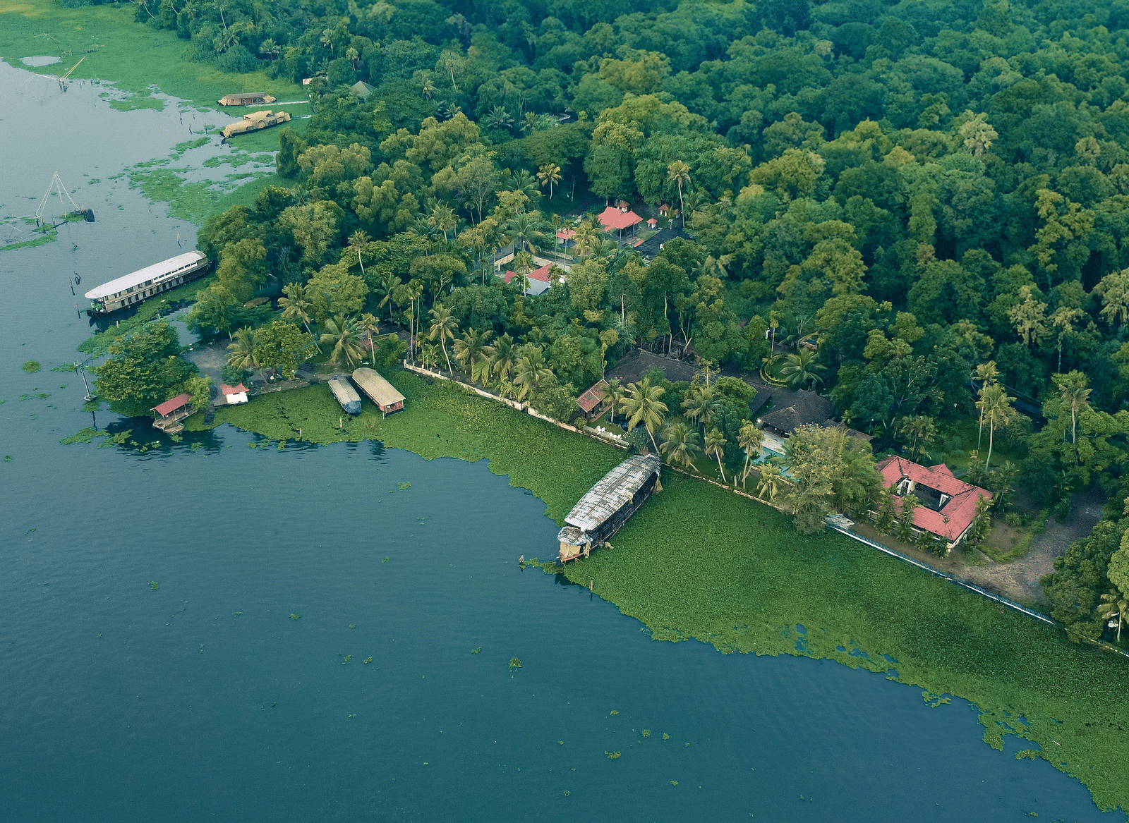 An aerial shot showcasing the Vembanad Lake and the resort surrounded by lush greenery - BluSalzz Villas - Muhamma Resort, Alleppey