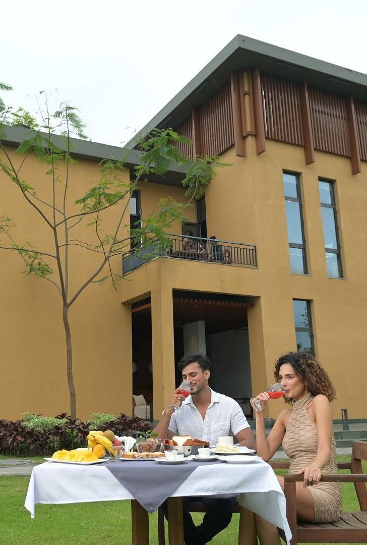 A couple having brunch in the outdoor dining area at Singalila Club