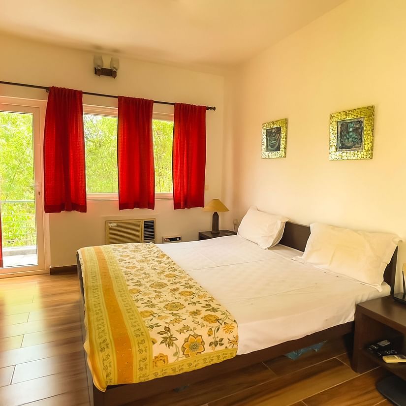 King bed with lamp on side table at el benito goa