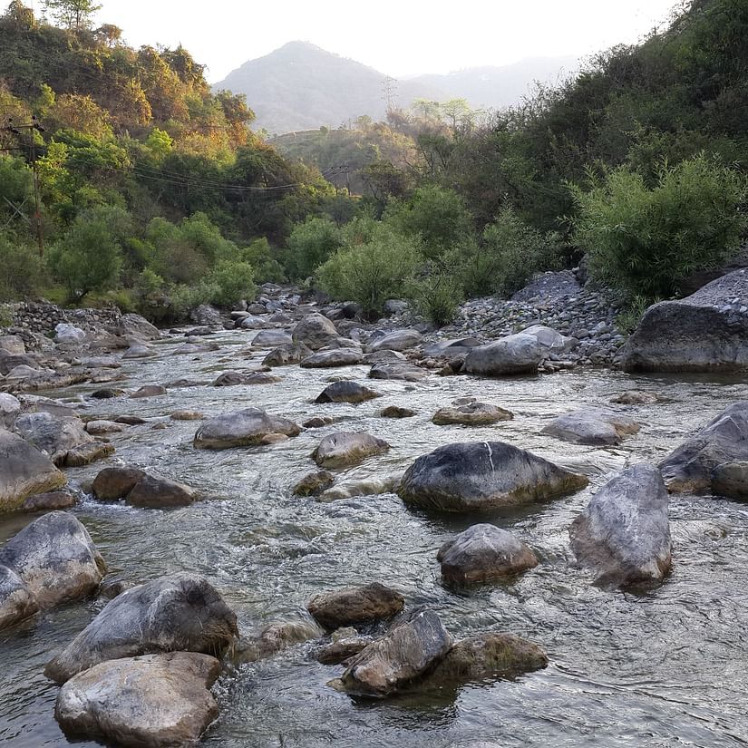  Rocky riverbed with clear water flowing through.