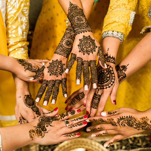 people showing hands with mehendi done