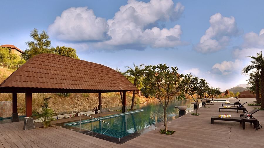 The swimming pool with the lounge chairs and trees enveloping it - The Ananta Udaipur