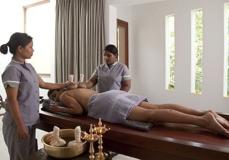 Two therapists performing a synchronized full-body Ayurvedic massage - Shreyas Retreat