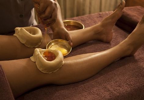 A relaxing leg massage using warm Ayurvedic oils - Shreyas Retreat