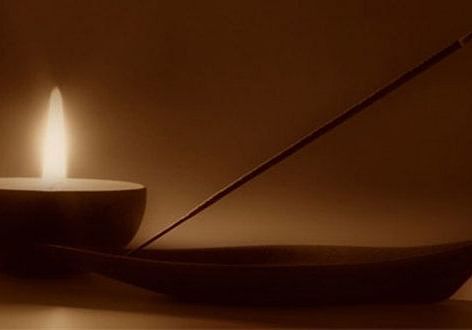 A close-up of a candle and incense, creating a peaceful spa ambiance - Shreyas Retreat