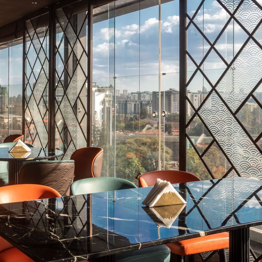 rooftop seating area in Asiatic Lounge with plush, modern chairs and artistic ceiling decor.