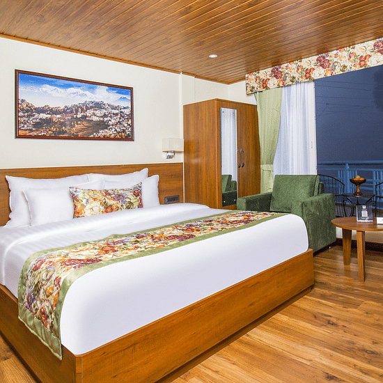 Side view of Suite With Balcony room with a cosy bed at Mount Lungta Boutique Hotel & Spa