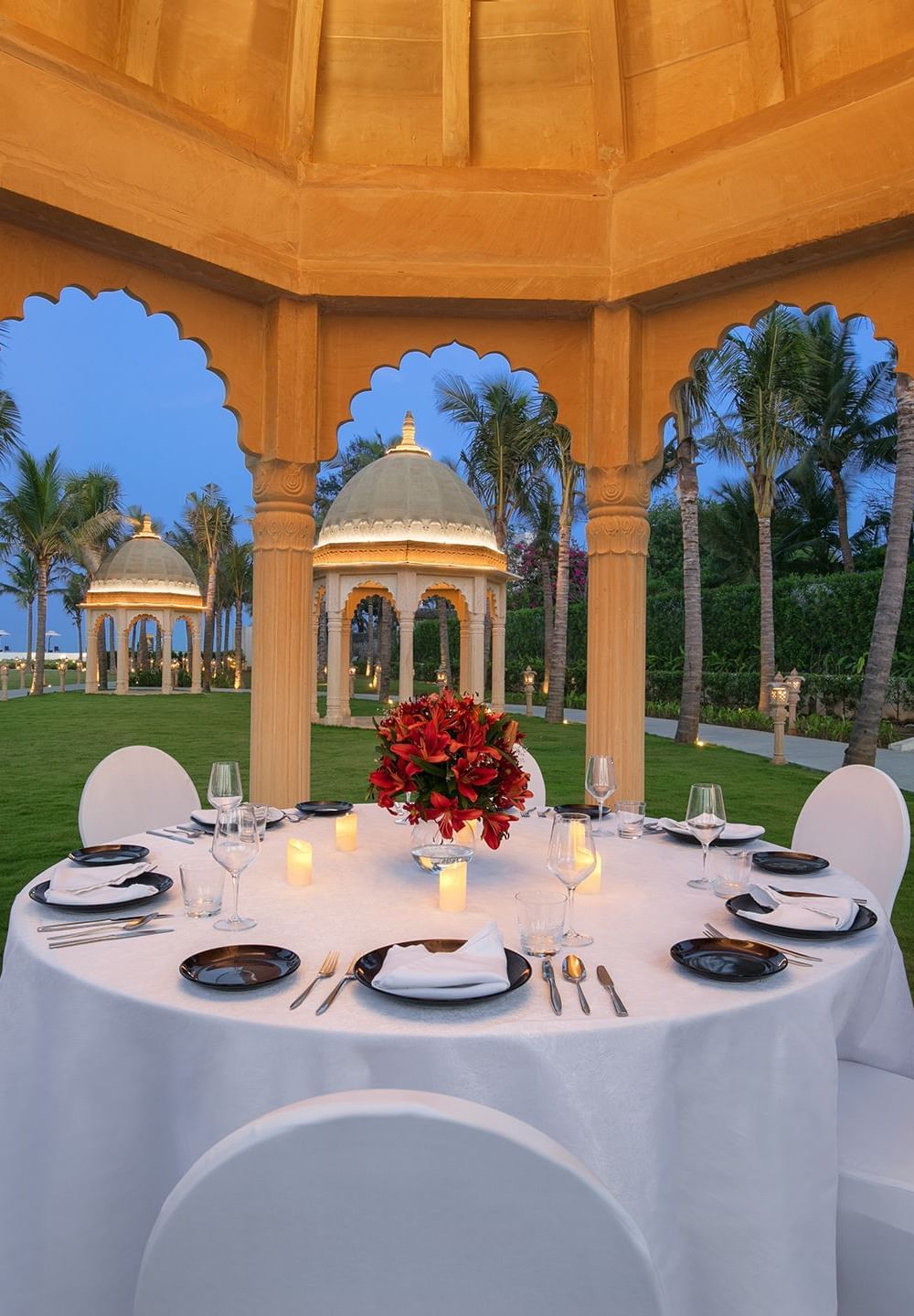 A gazebo with a dining setup, cosy lighting and views of the sea - Kaldan Samudhra Palace