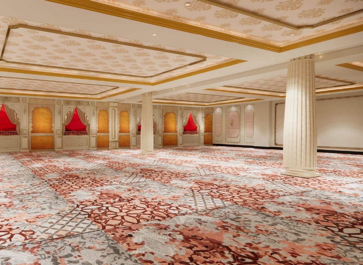 Grand banquet hall with elegant ceilings featuring floral motifs, large pillars, ambient lighting, and walls styled like traditional Indian windows.