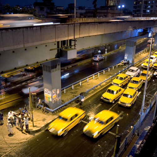 overhead view of many yellow taxis in queue to fetch passengers
