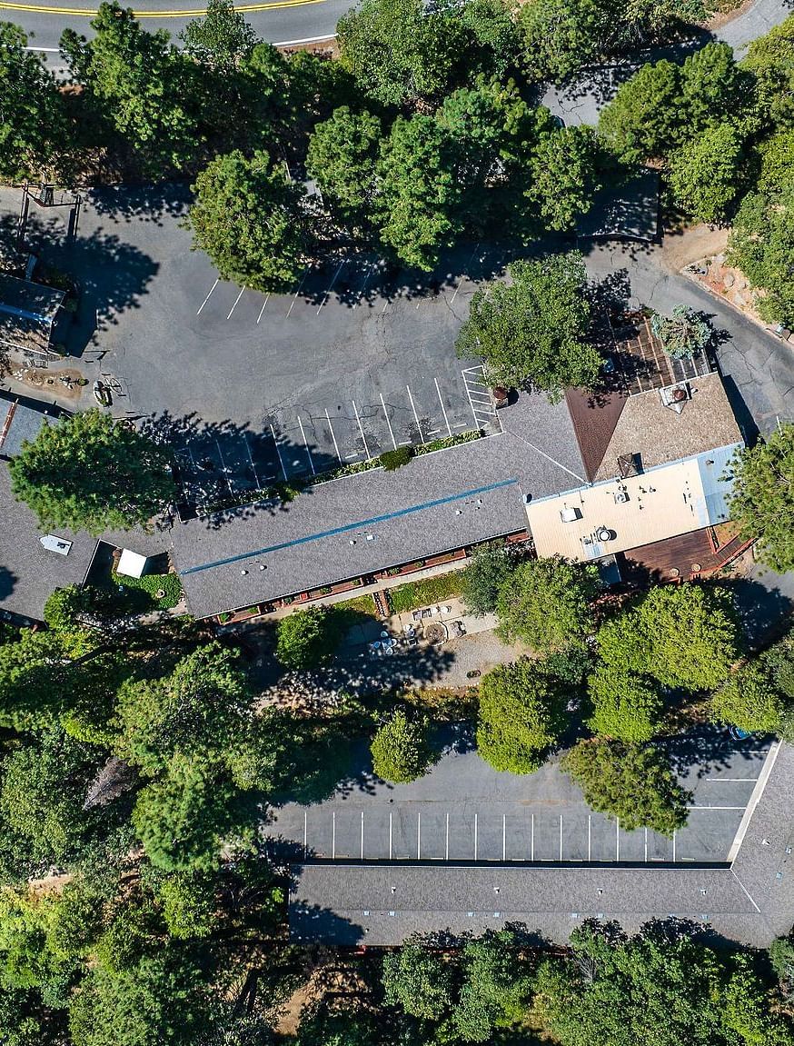 A top down aerial view of the property in the middle of the forest - Narrow Gauge Inn - A Serenite Hotel Near Fish Camp.