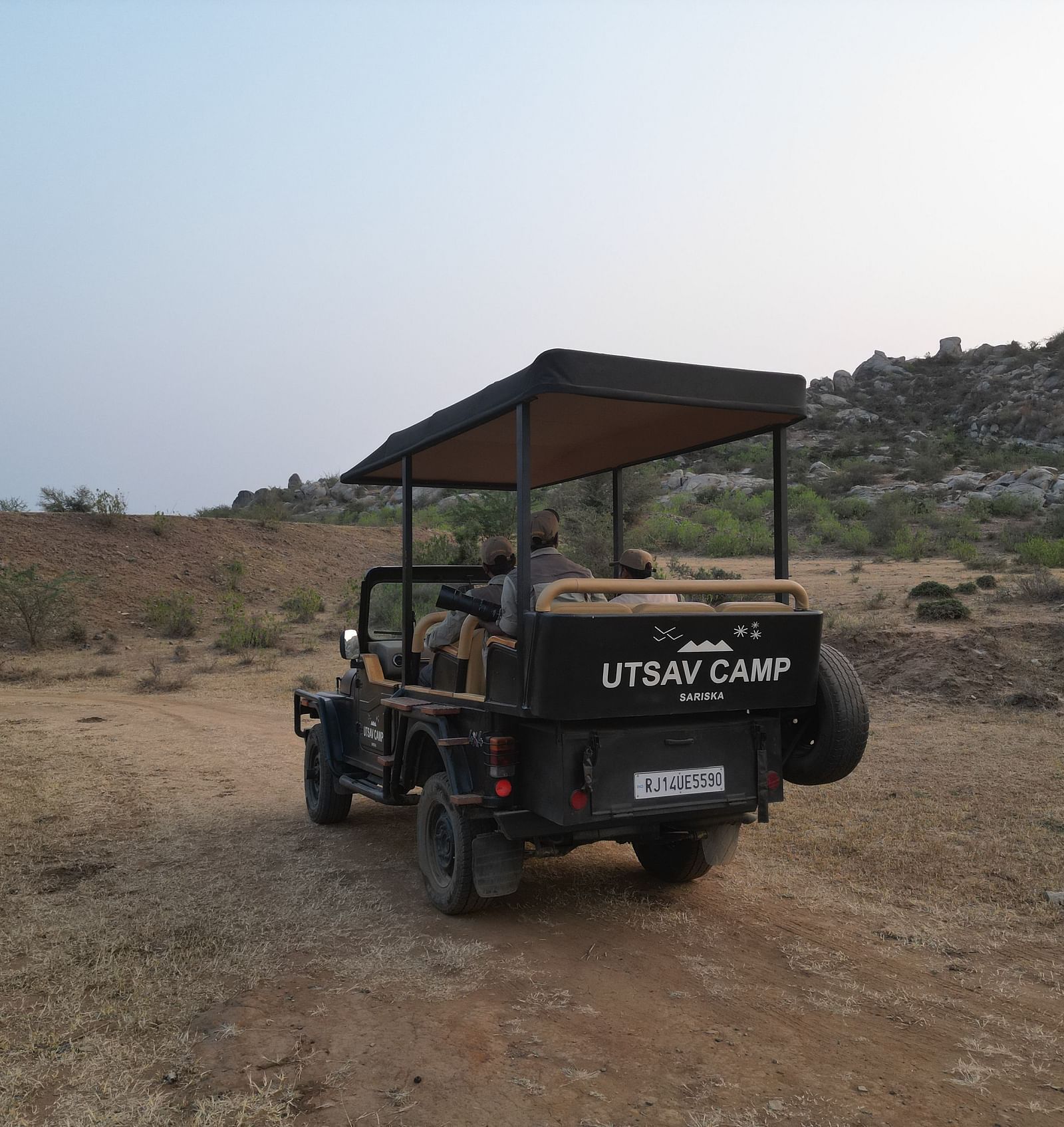 An image of a jeep parked amidst the rocky mountains - Utsav Camp Sariska