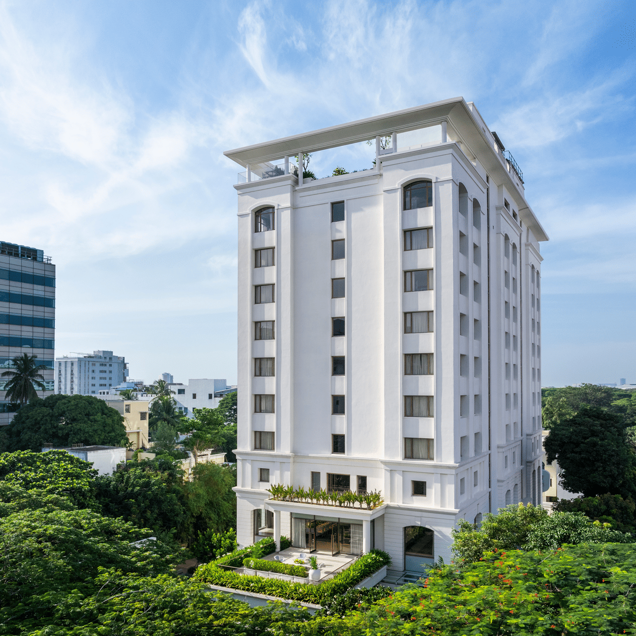 Exterior view of hotel building surrounded by greenery at The Raintree, St. Mary’s Road.