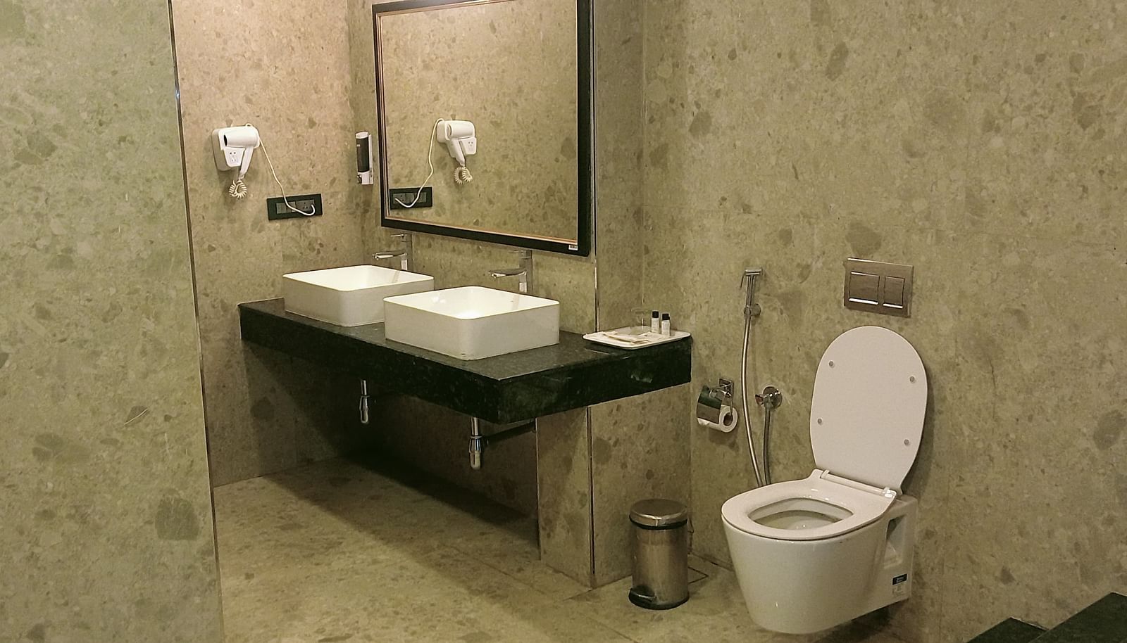 image of the bathroom of the artist suite featuring a commode and a well appointed vanity area 