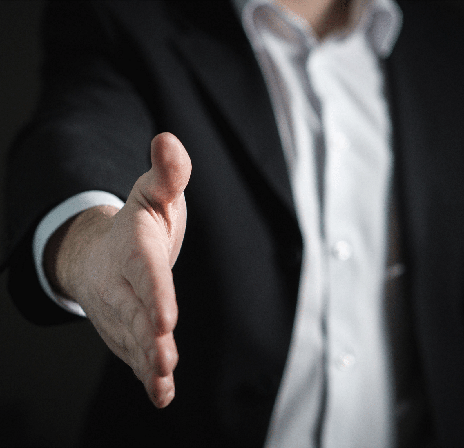Businessman offering a handshake.