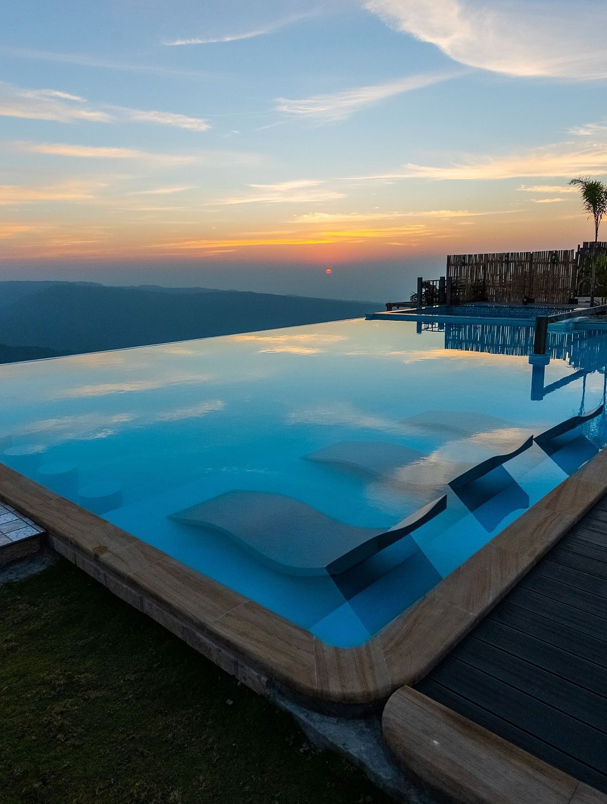 A infinity pool at sunset with panoramic mountain views - Polo Resort Cherrapunjee