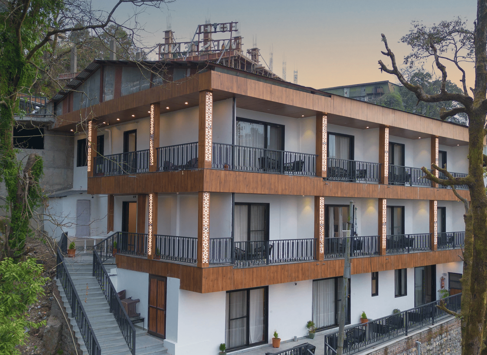 A beautiful facade of the Perfectstayz Premium Westend Mall Road, Mussoorie, featuring a 3-storey building with balconies.