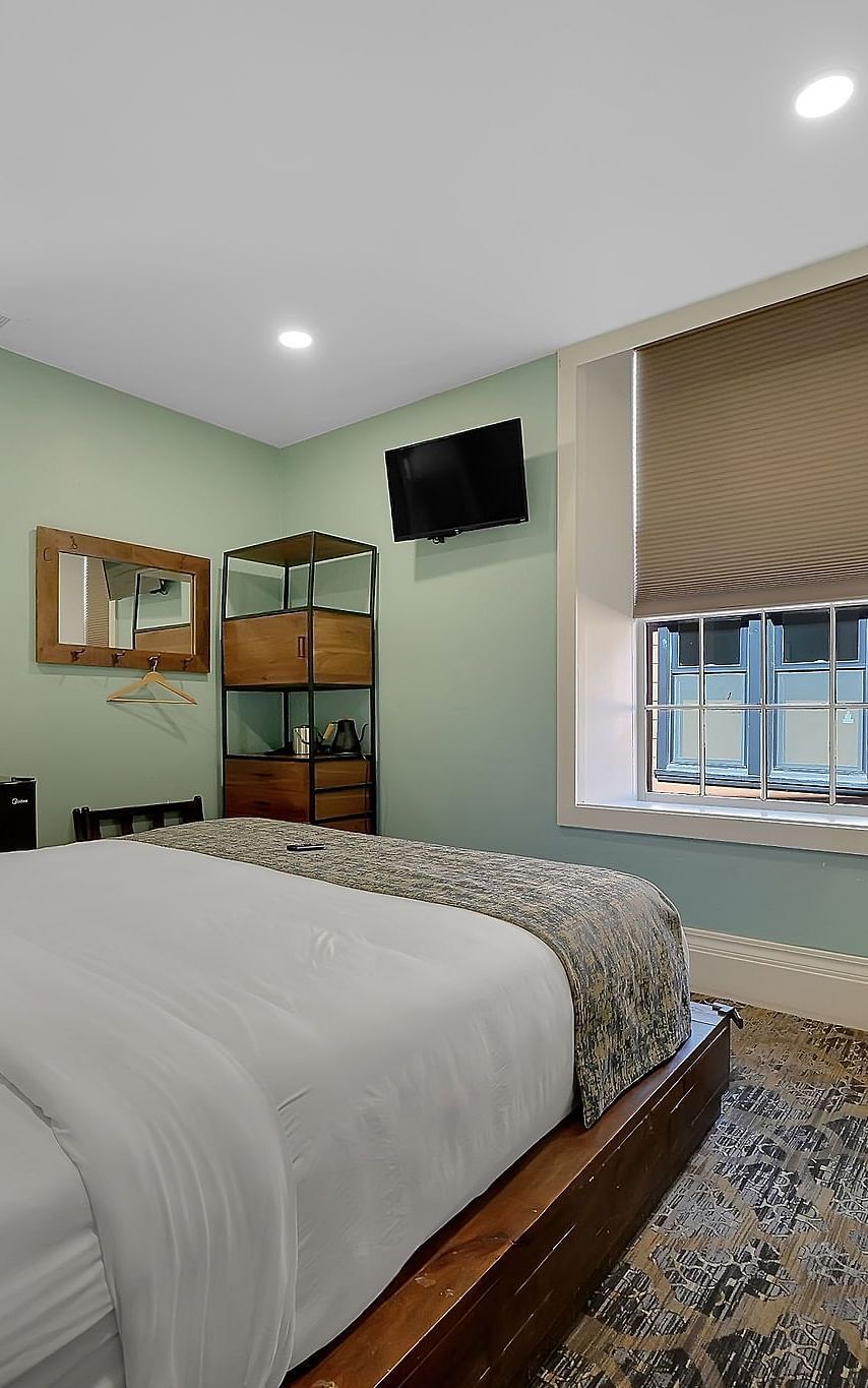 A view of a room at The Groveland Hotel with a double bed.