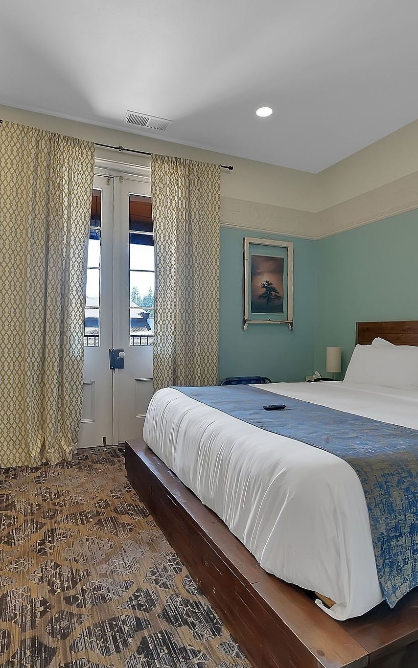 A view of a room at The Groveland Hotel with a double bed.
