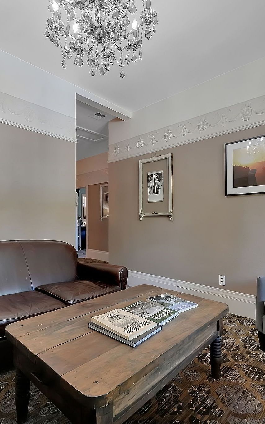 Living room area of a suite at The Groveland Hotel with sofa seating and a coffee table.