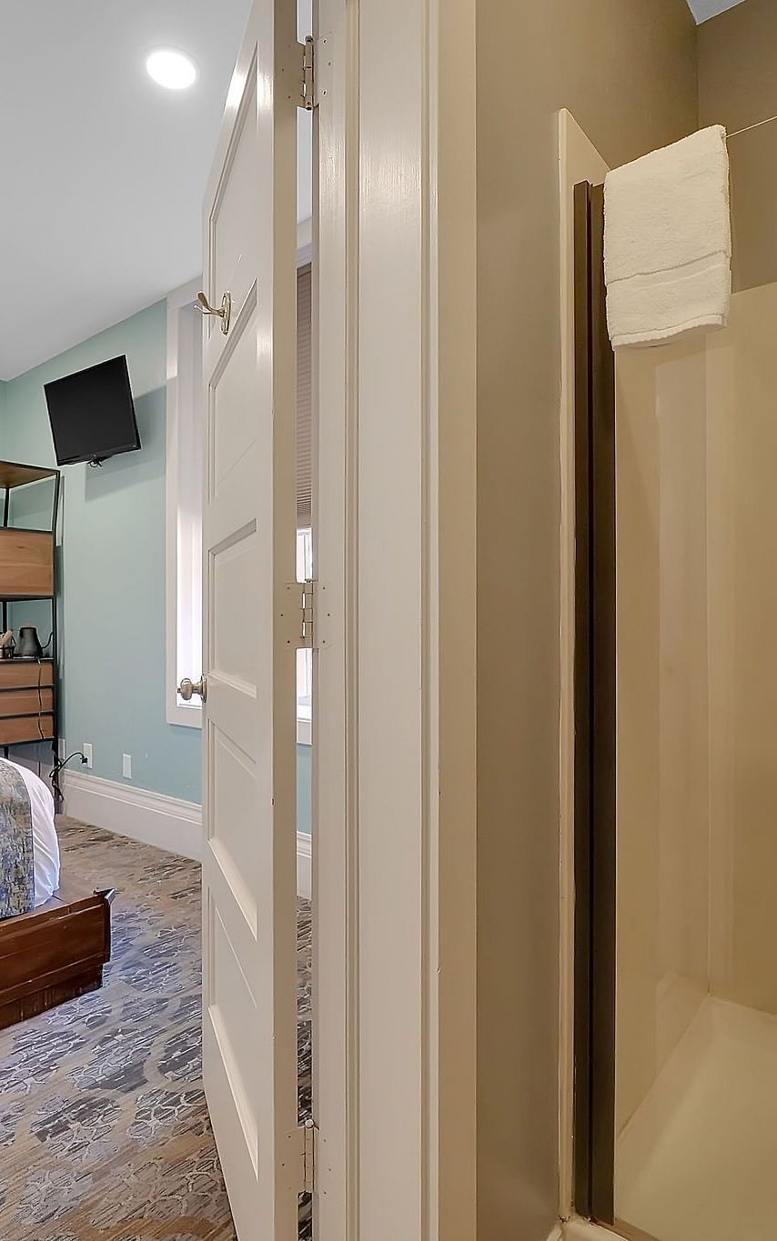 A view of a room at The Groveland Hotel with a double bed.