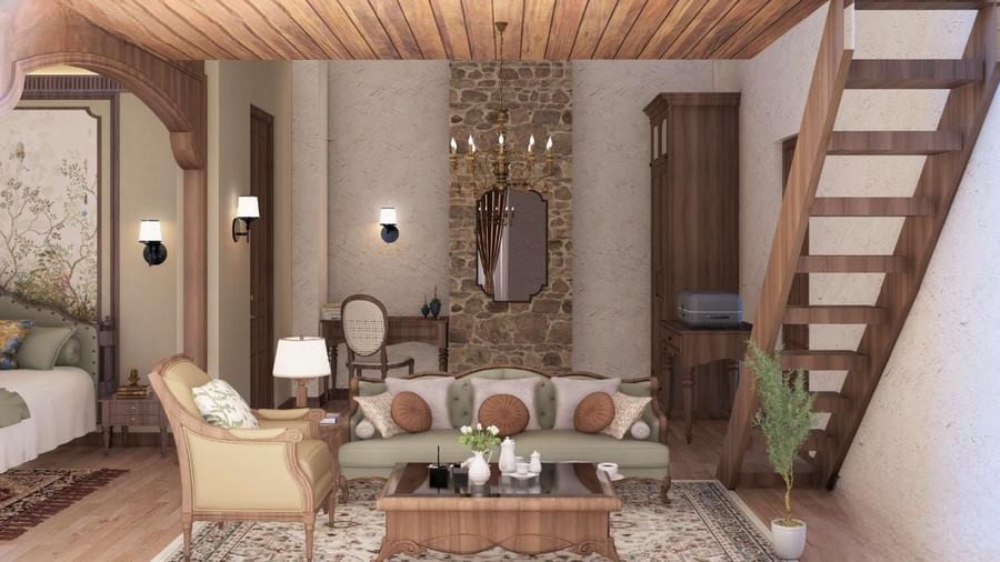 Rustic living area with a wooden staircase, stone wall details, and a sofa with patterned cushions at BluSalzz Terrah Hills Resort, Dalhousie.