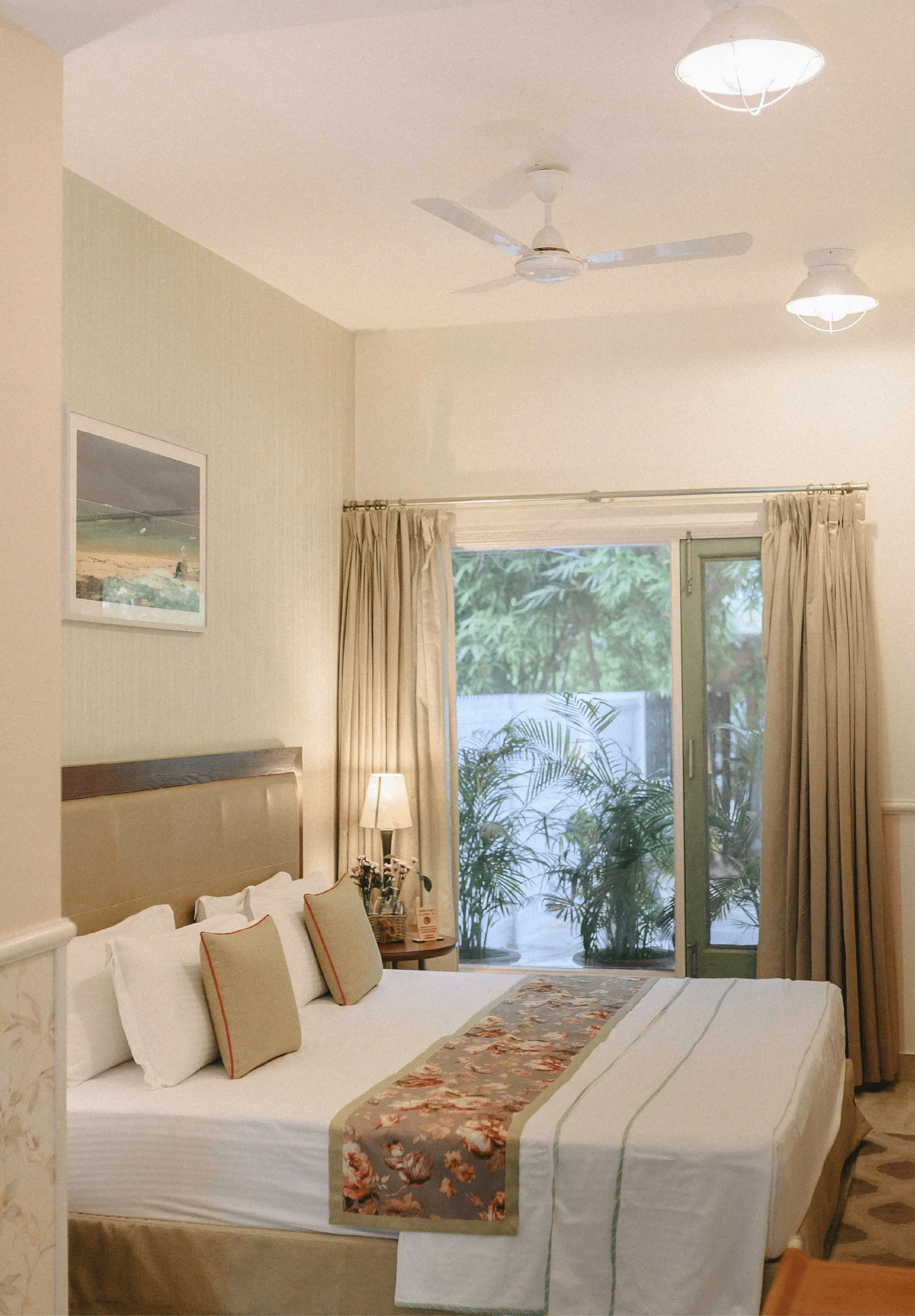 Well lit bedroom at Karma Chalets with a double bed, window view, and wall decor.