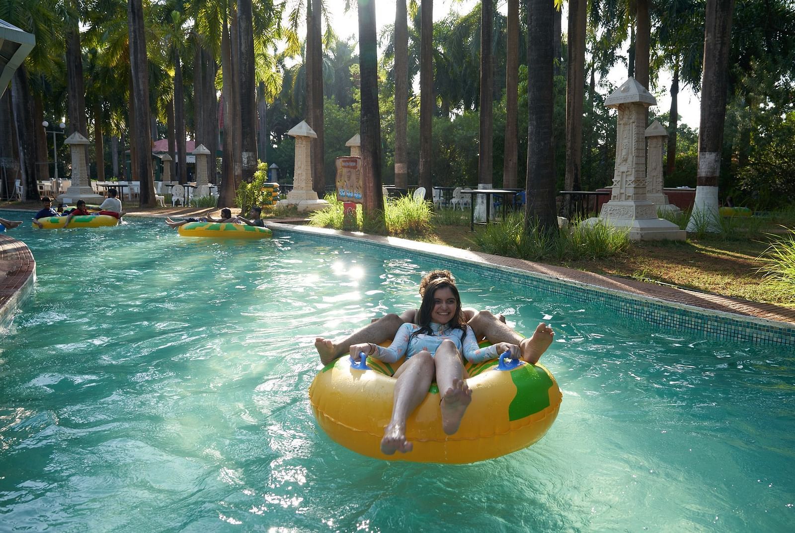 An image of a two people enjoying the lazy river on a tube - Water Kingdom
