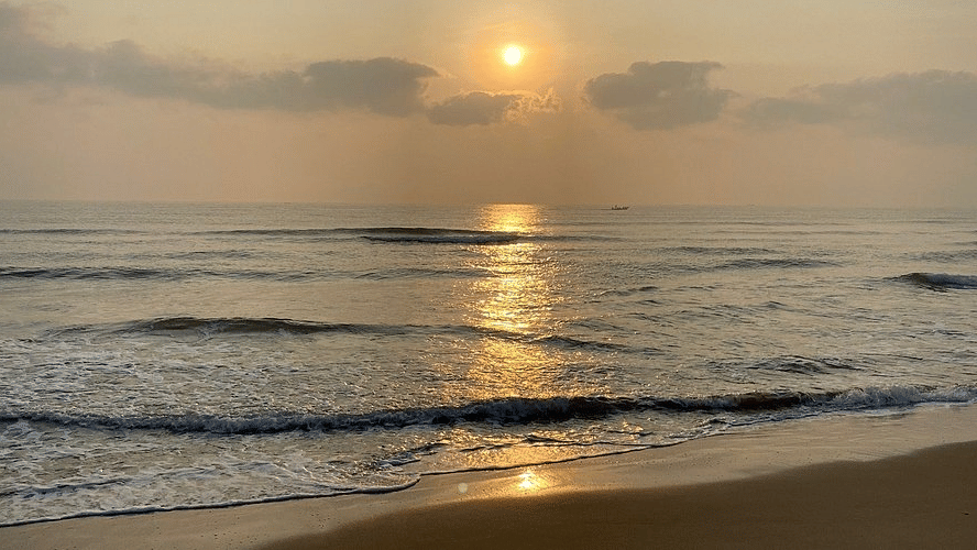A serene sunrise reflecting on the waves of the ocean at the private beach access of MGM Beach Resorts, ECR Chennai.