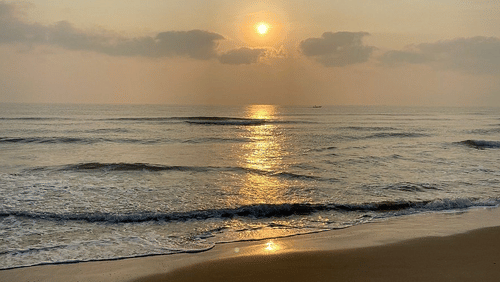 A serene sunrise reflecting on the waves of the ocean at the private beach access of MGM Beach Resorts, ECR Chennai.