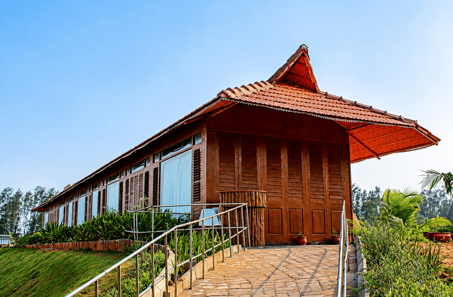 Spa building exterior with a traditional thatched roof design and garden pathway at Chariot Beach Resort, blending nature with wellness.