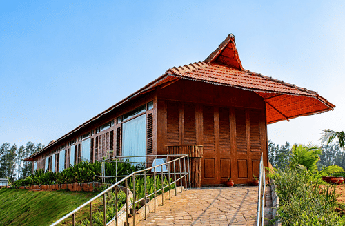 Spa building exterior with a traditional thatched roof design and garden pathway at Chariot Beach Resort, blending nature with wellness.