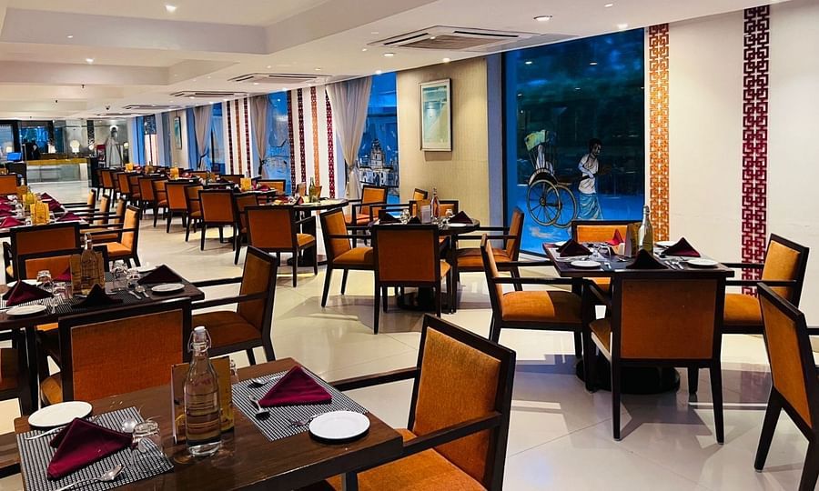 A corner view of the restaurant interior with multiple tables and chairs arranged for guests