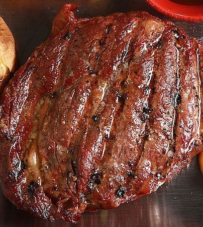 A close-up of a grilled ribeye steak. - Kit Carson Lodge & Restaurant