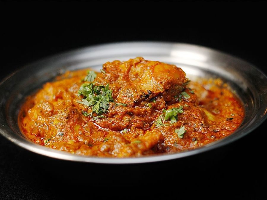 Chicken Tikka Masala plated in a steel dish