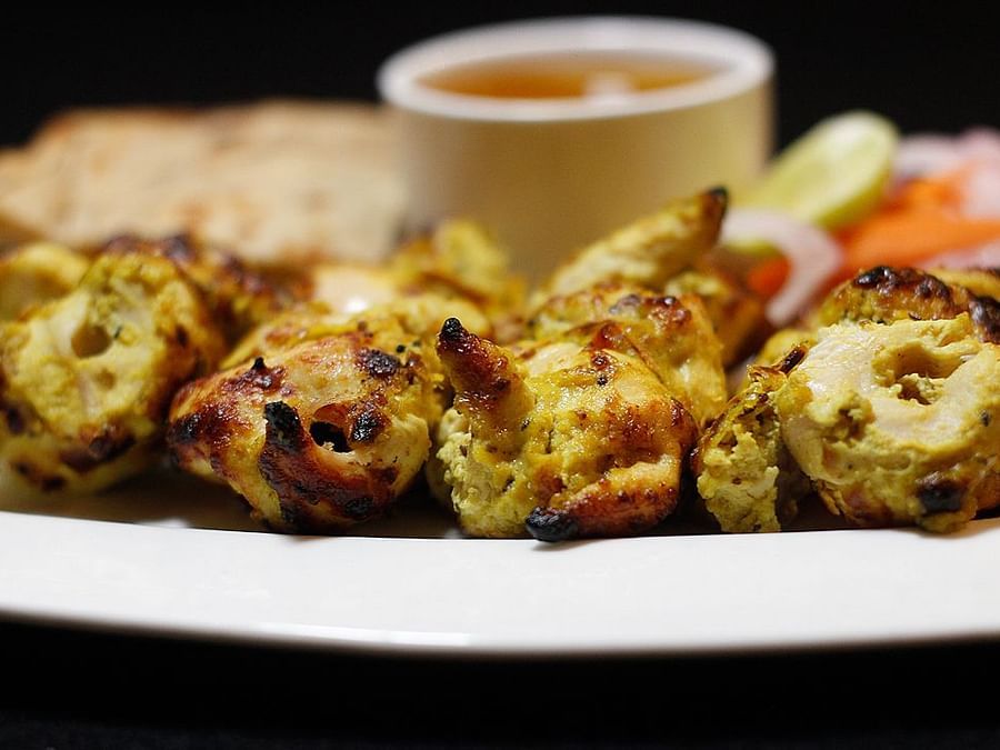Reshmi Kebab plated in a white plate with a dip