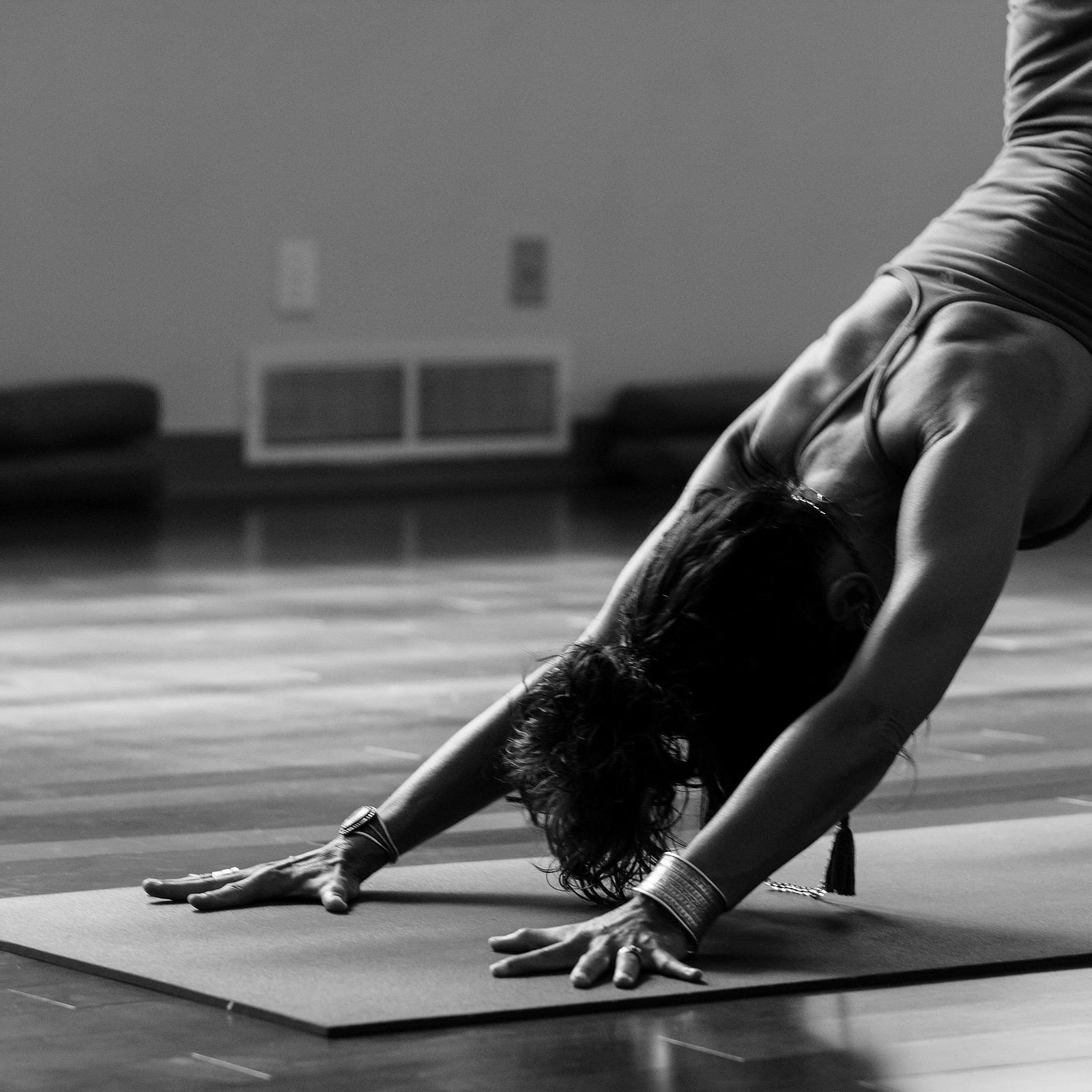 A women stretching and performing yoga in a room.