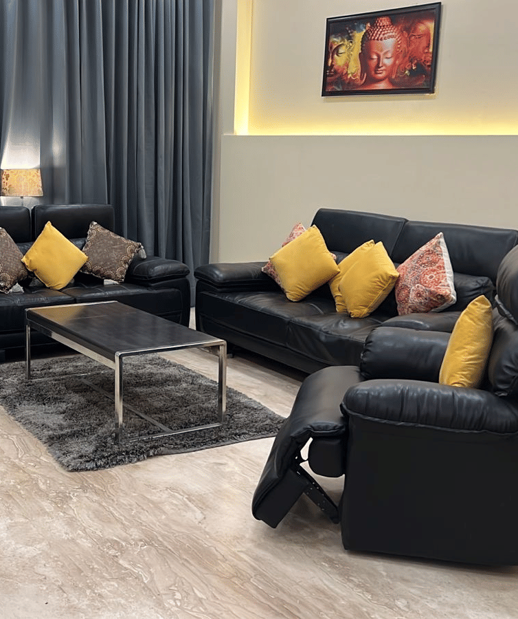 Sofas in front of the TV at Lime Tree 3BHK Serviced Apartments, DLF Phase - 5 Gurgaon